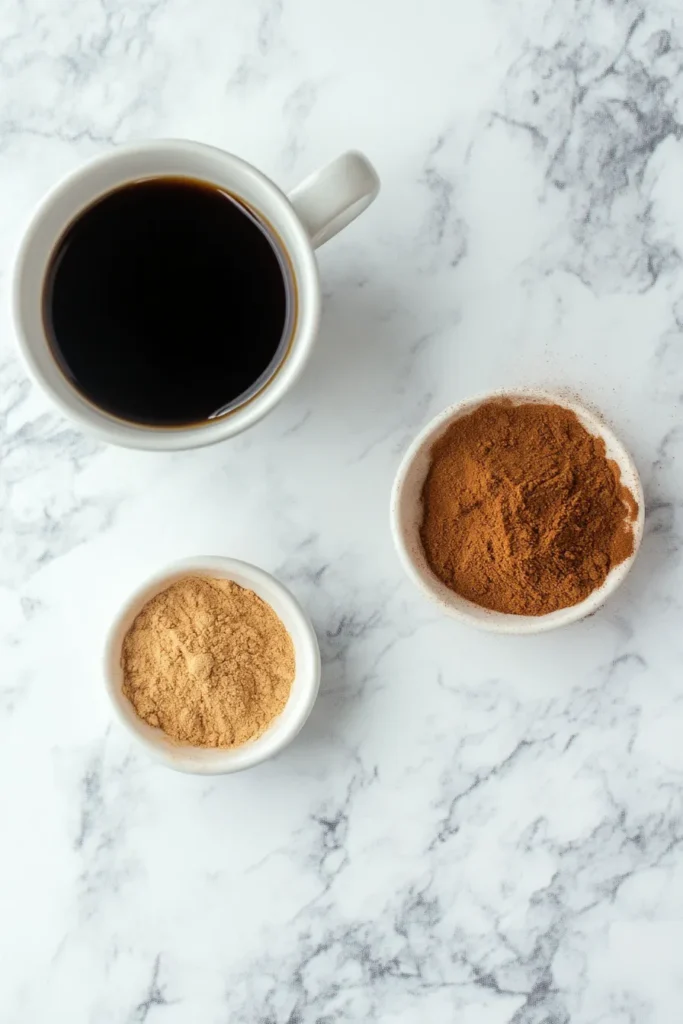 Hot black coffee, MCT oil, and cinnamon powder displayed on a bright kitchen counter for the 2 ingredient coffee loophole recipe.