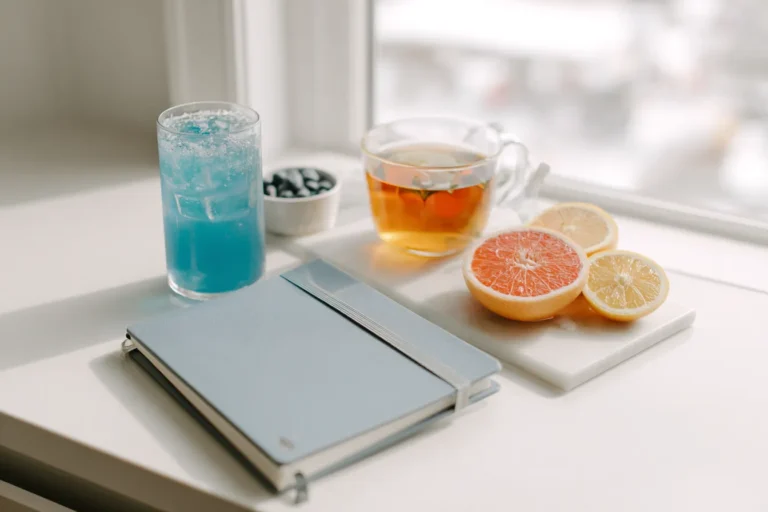 Flat lay of a morning health routine with Blue Salt Trick drink and natural light in a bright, organized kitchen.